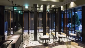 A modern interior with a seating area, glass partitions, and a view of the outside. - Stay Hotel Gangnam (Seoul)