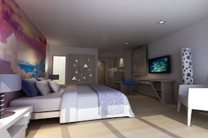A modern bedroom with a bed, desk, and chair.