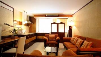 Suíte, 2 quartos, no canto | Área de estar | TV 32 polegadas com canais a cabo