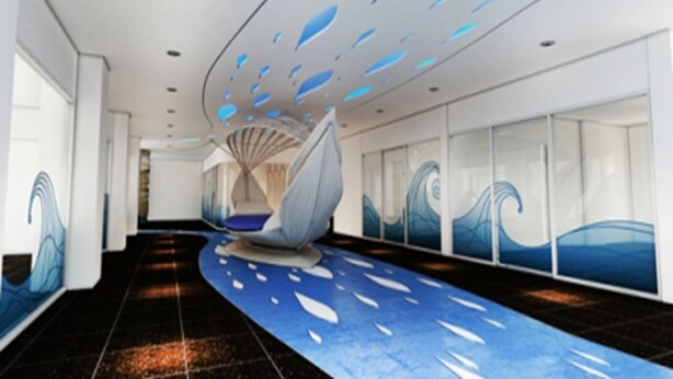 A modern hotel lobby with a curved ceiling, wave-themed wall art, and a central seating area. - The Pacific Cool Chic (Chiang Mai)