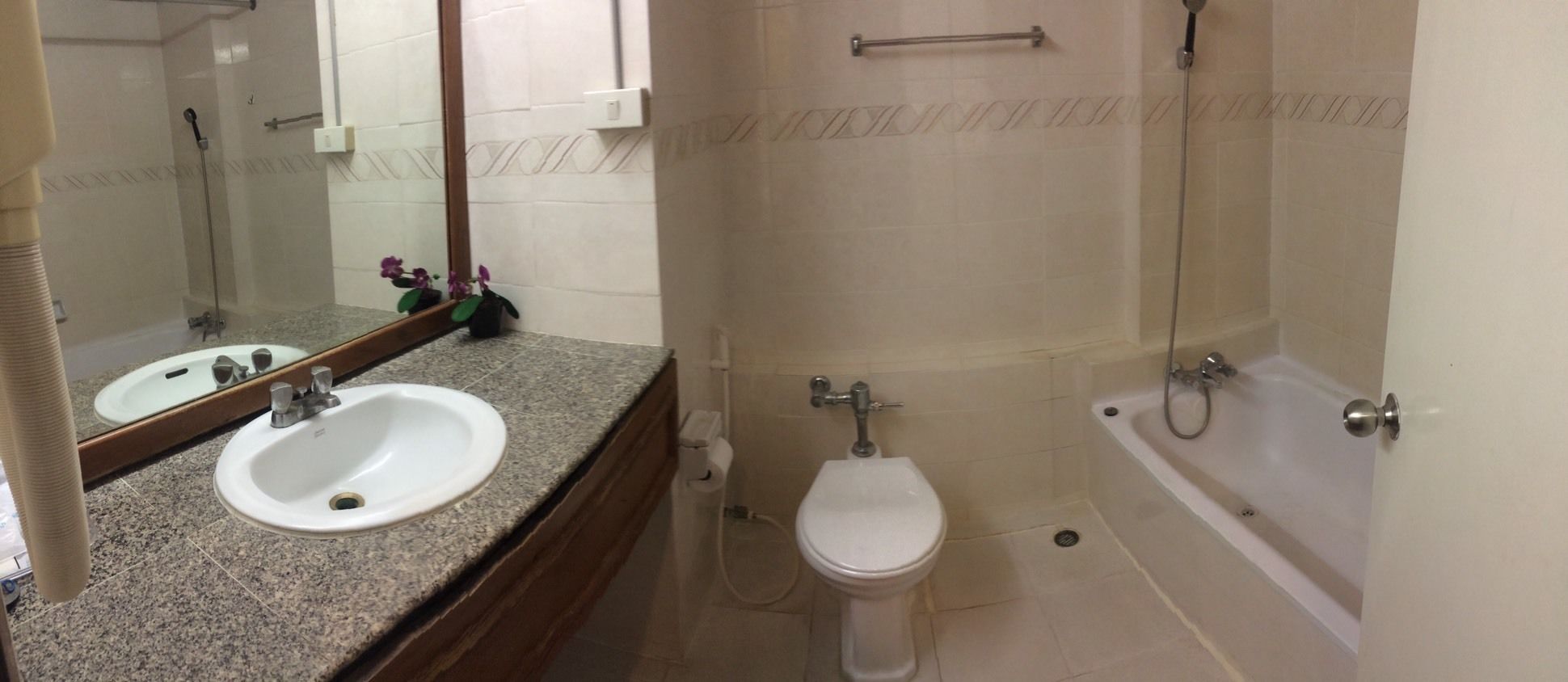 A bathroom with a sink, toilet, and bathtub.