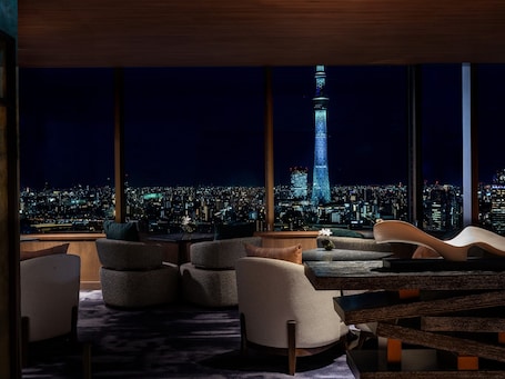 A modern interior with a cityscape view, including a prominent tower.