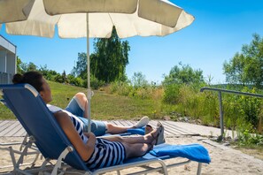 On the beach, sun loungers, kayaking, rowing