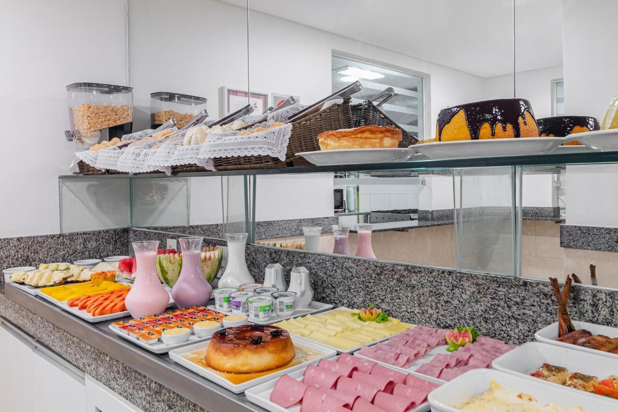 A buffet with various food items and beverages.
