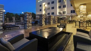 A Residence Inn Marriott hotel with outdoor seating, stone pillars, and a well-lit patio area. - Residence Inn by Marriott Houston West/Beltway 8 at Clay Rd. (Houston)