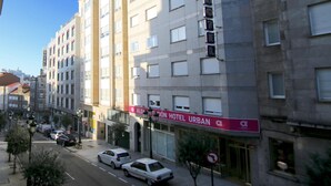 A multi-story hotel with a prominent "Aldan Hotel Urban" sign. The building features a modern architectural style with large windows and a flat facade. - Alda Estación Vigo (Vigo)