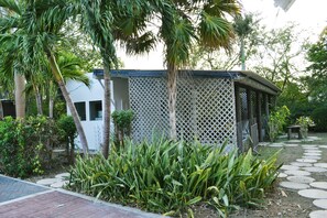 A garden with a gazebo, palm trees, and a pathway. - Palm Trees Apartments (Willemstad)