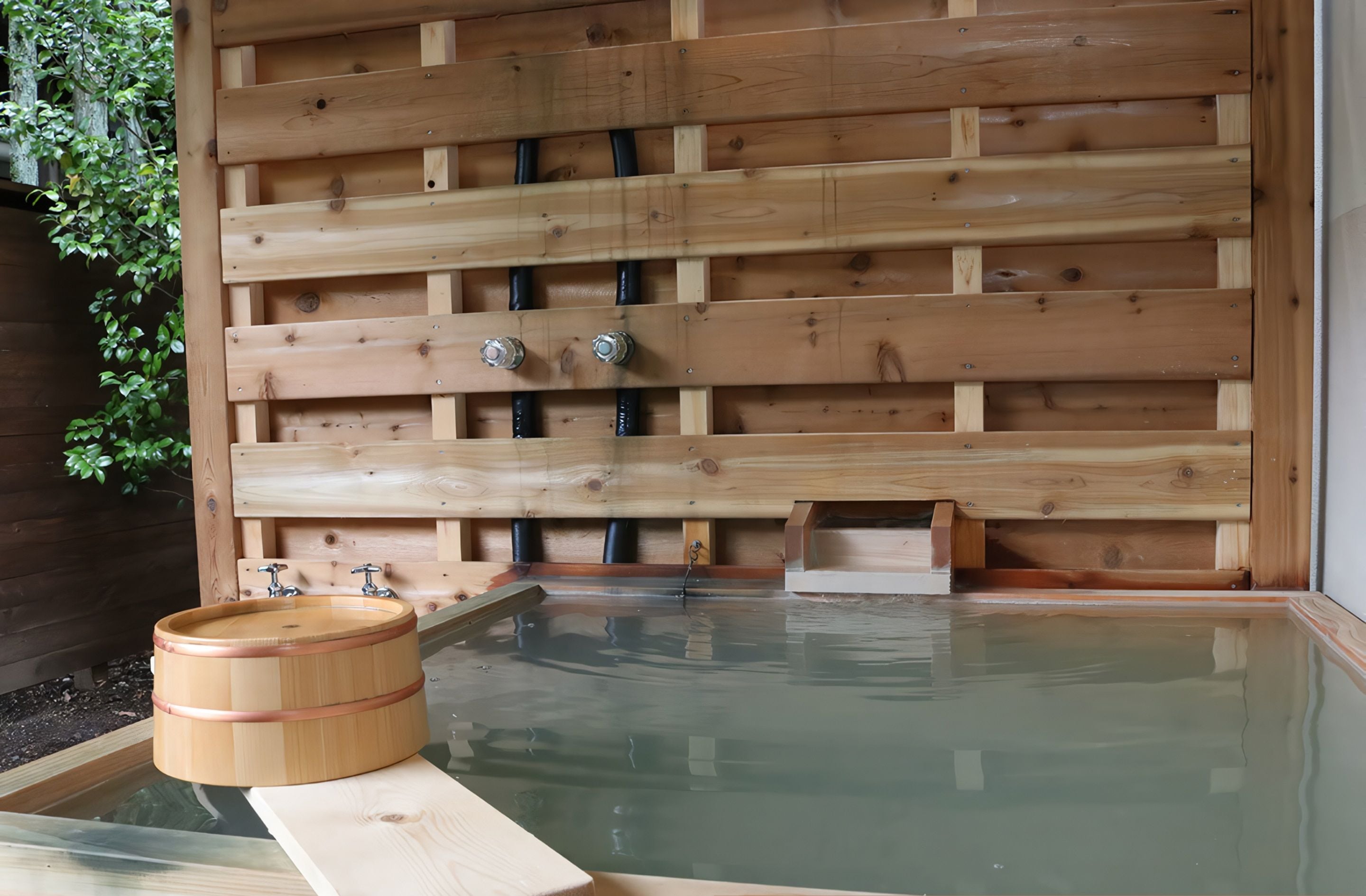 A wooden bath area with a wooden tub and a wooden bench.