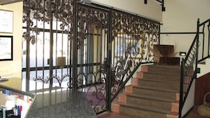 A staircase with ornate metal railings and a view of the outside. - Benvenuto Conference and Train (Randburg)
