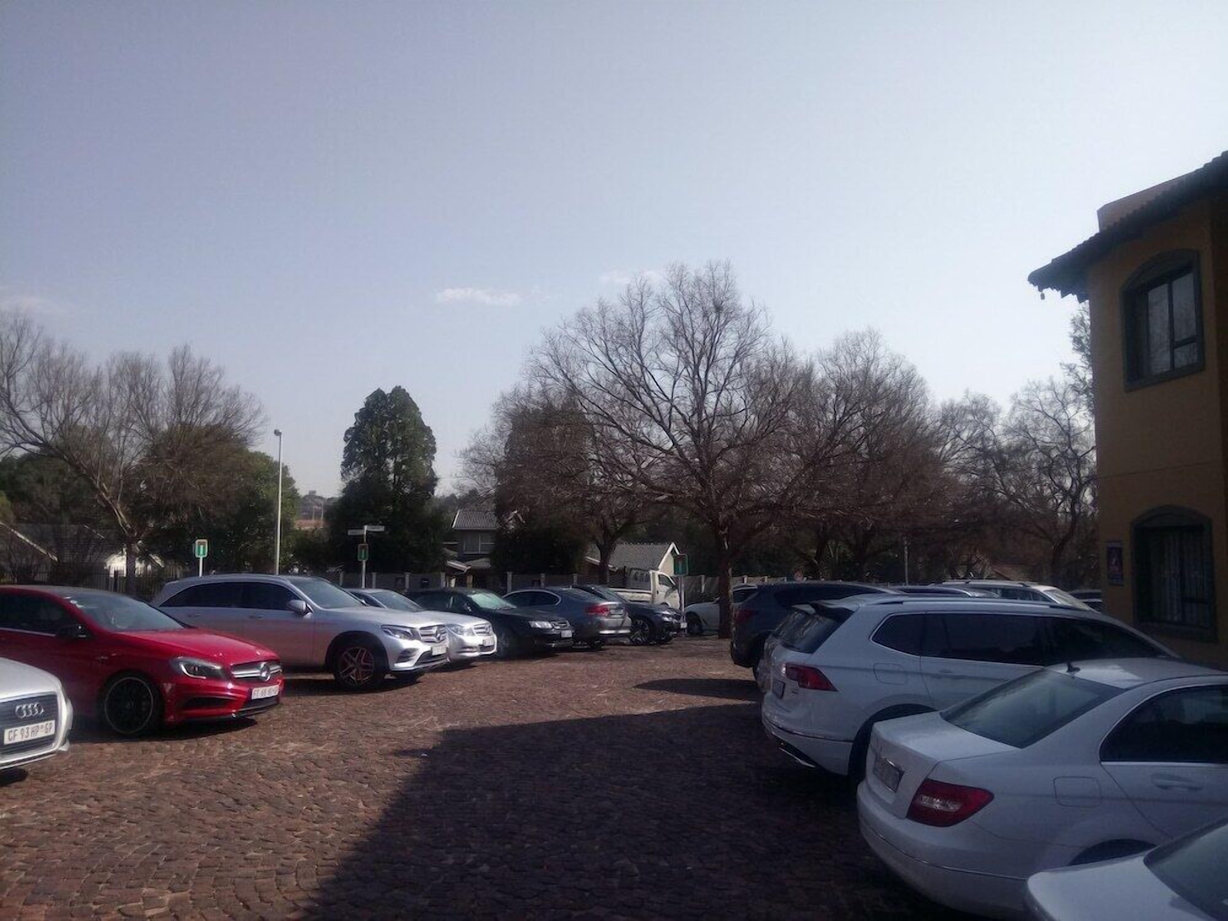 A parking lot with several cars parked.