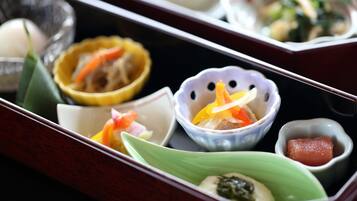 A traditional Japanese bento box with various food items.
