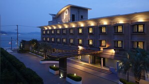 A modern hotel with a prominent clock tower, multiple balconies, and a waterfront view. - Kamakura Park Hotel (Kamakura)