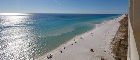 A beach with clear turquoise waters and a sandy shore.