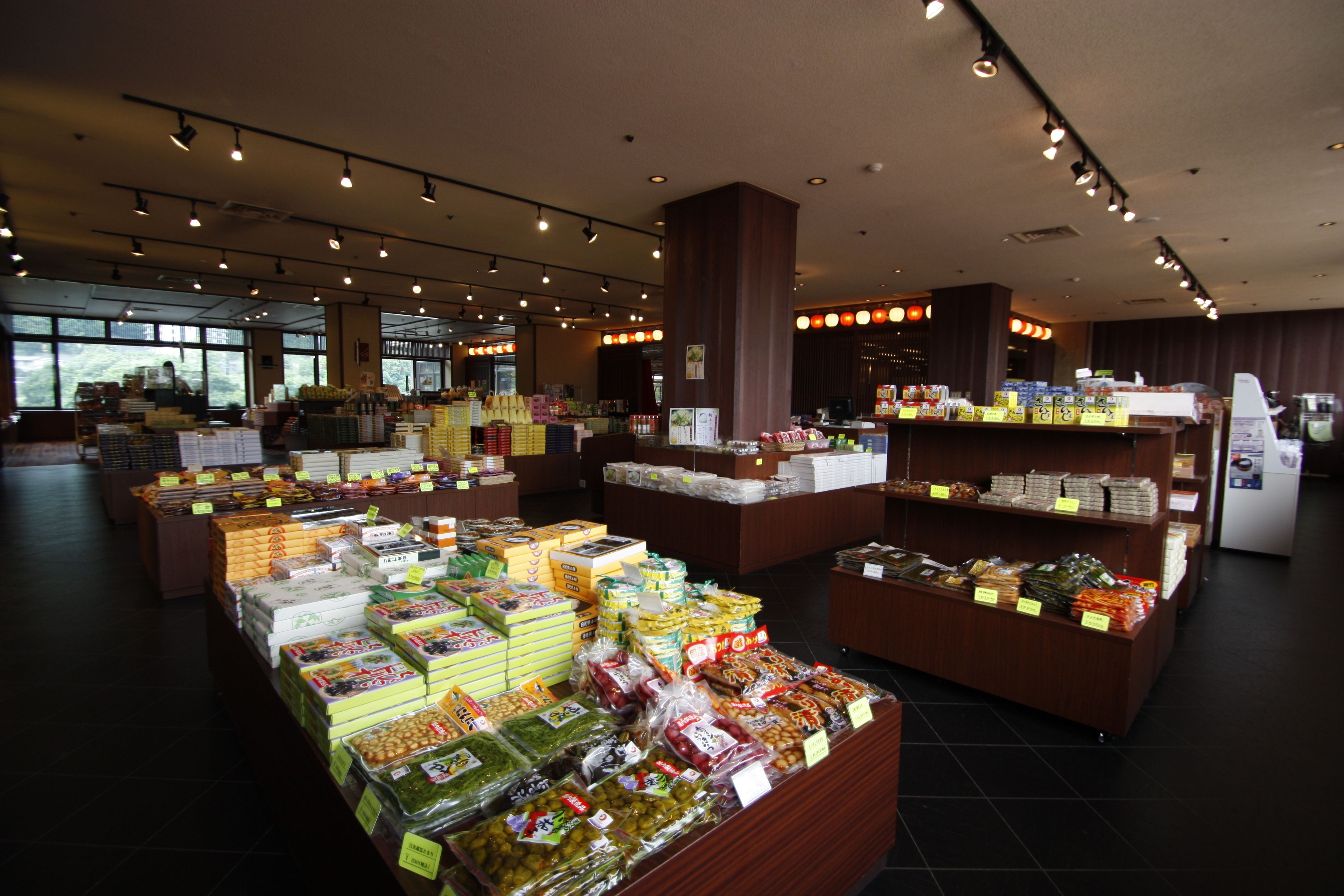 A grocery store with multiple aisles and shelves stocked with various products.