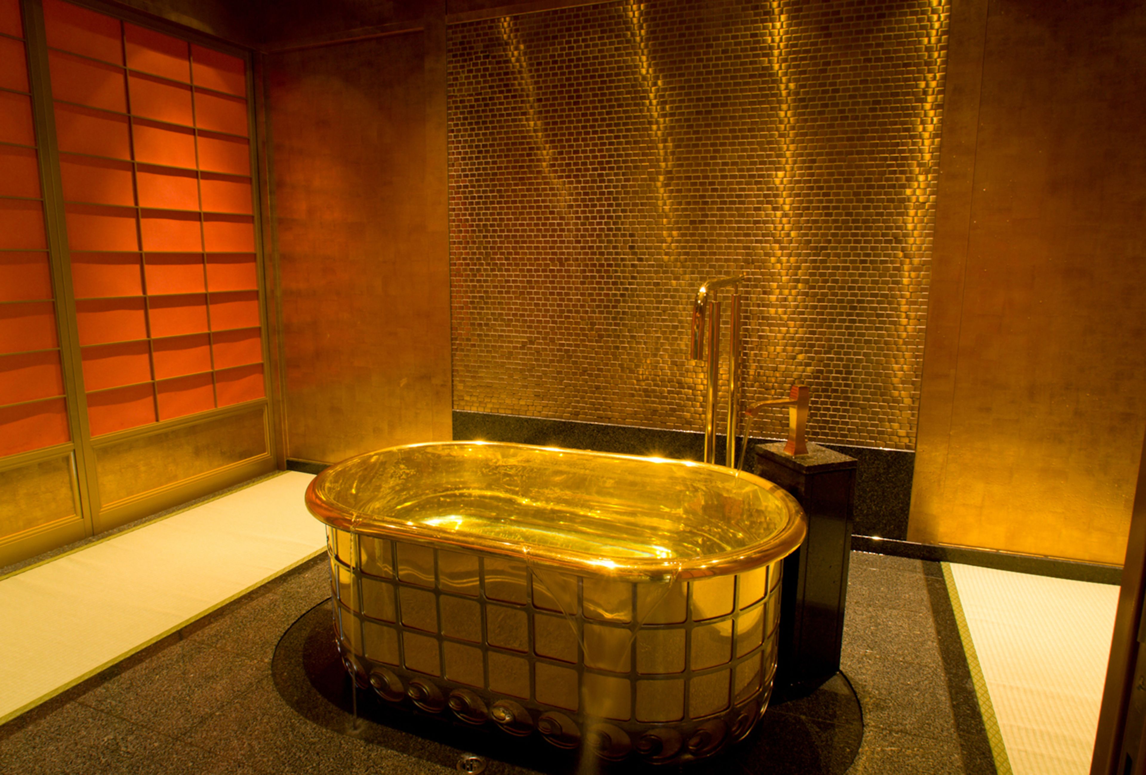 A spa room with a large, rectangular, glass-enclosed hot tub.