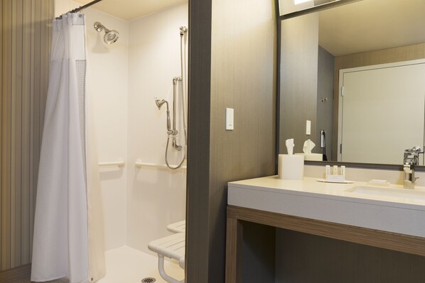 A modern bathroom with a shower, toilet, and sink. - Courtyard Mt. Pleasant at Central Michigan University (Mount Pleasant)