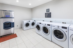A laundry facility with multiple washing machines and a commercial dryer.