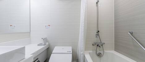 A modern bathroom with a toilet, sink, and bathtub.