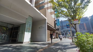 A modern building with a large glass facade and a sign for 'Blogom'.