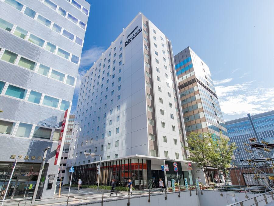 A modern hotel with a prominent 'BlockZ' sign, large windows, and a glass facade.