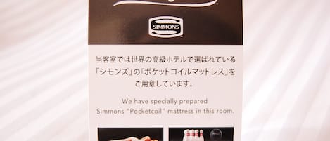 A brochure for a Beautyrest Simmons mattress in a hotel room.