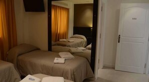Ein Hotelzimmer mit zwei Betten, einem Fernseher und einer Tür mit der Nummer 604.