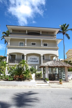 A two-story building with a sign reading "Corales Colonial."