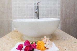 A bathroom sink with a white basin and a modern faucet.