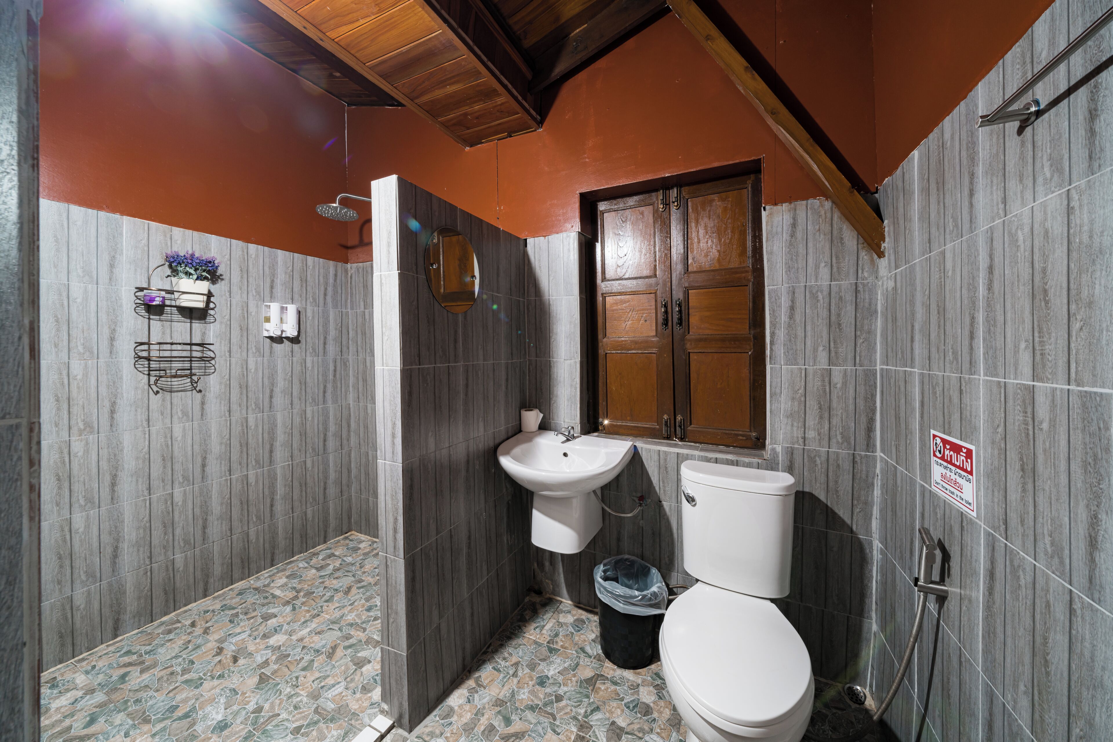 A bathroom with a toilet, sink, and shower.