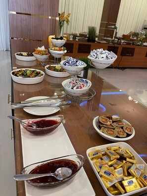 A buffet table with various food items and condiments. - Sama Inn Hotel (Riyadh)