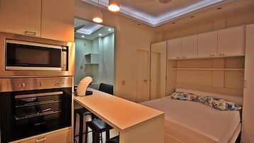 Deluxe Apartment, City View | Desk, blackout curtains, iron/ironing board