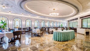 A grand dining hall with ornate ceiling and chandeliers, large windows, and a polished marble floor. - Shanghai Donghu Hotel (Shanghai)