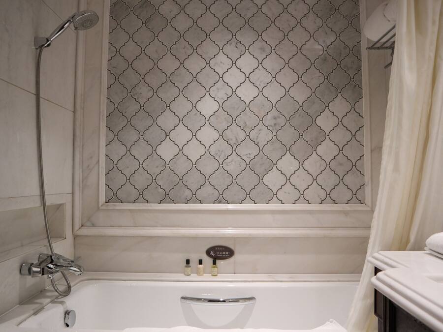 A bathroom with a shower, a bathtub, and a vanity with a towel.