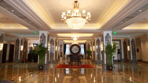 A grand lobby with a chandelier, marble columns, and a central seating area. - Shanghai Donghu Hotel (Shanghai)