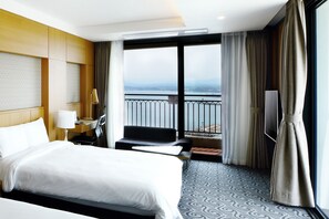 Enjoy a comfortable stay with a large bed, desk, and flat-screen TV, plus a balcony with a view of the water.