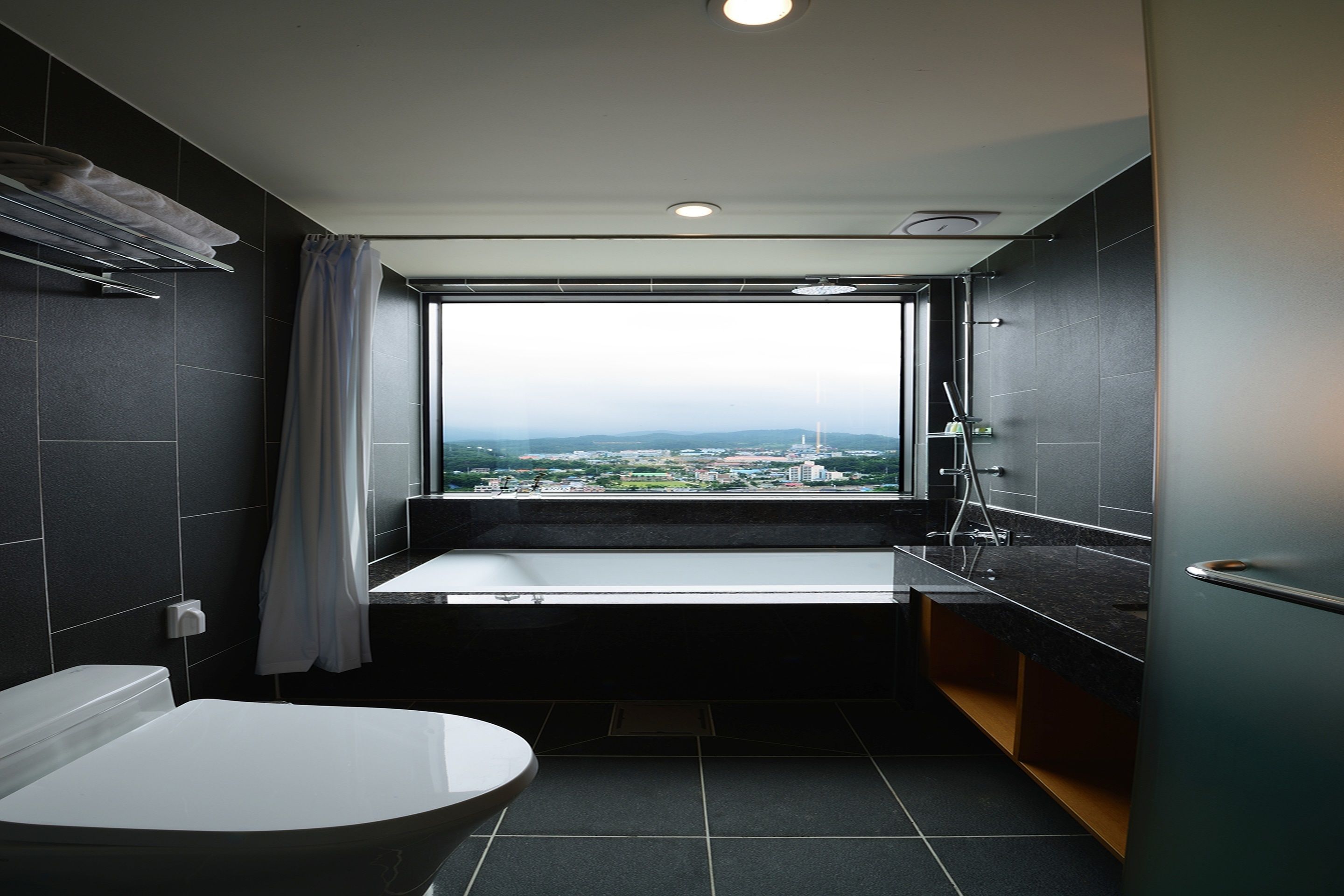 executive suite | bathroom | hair dryer, slippers, bidet, towels