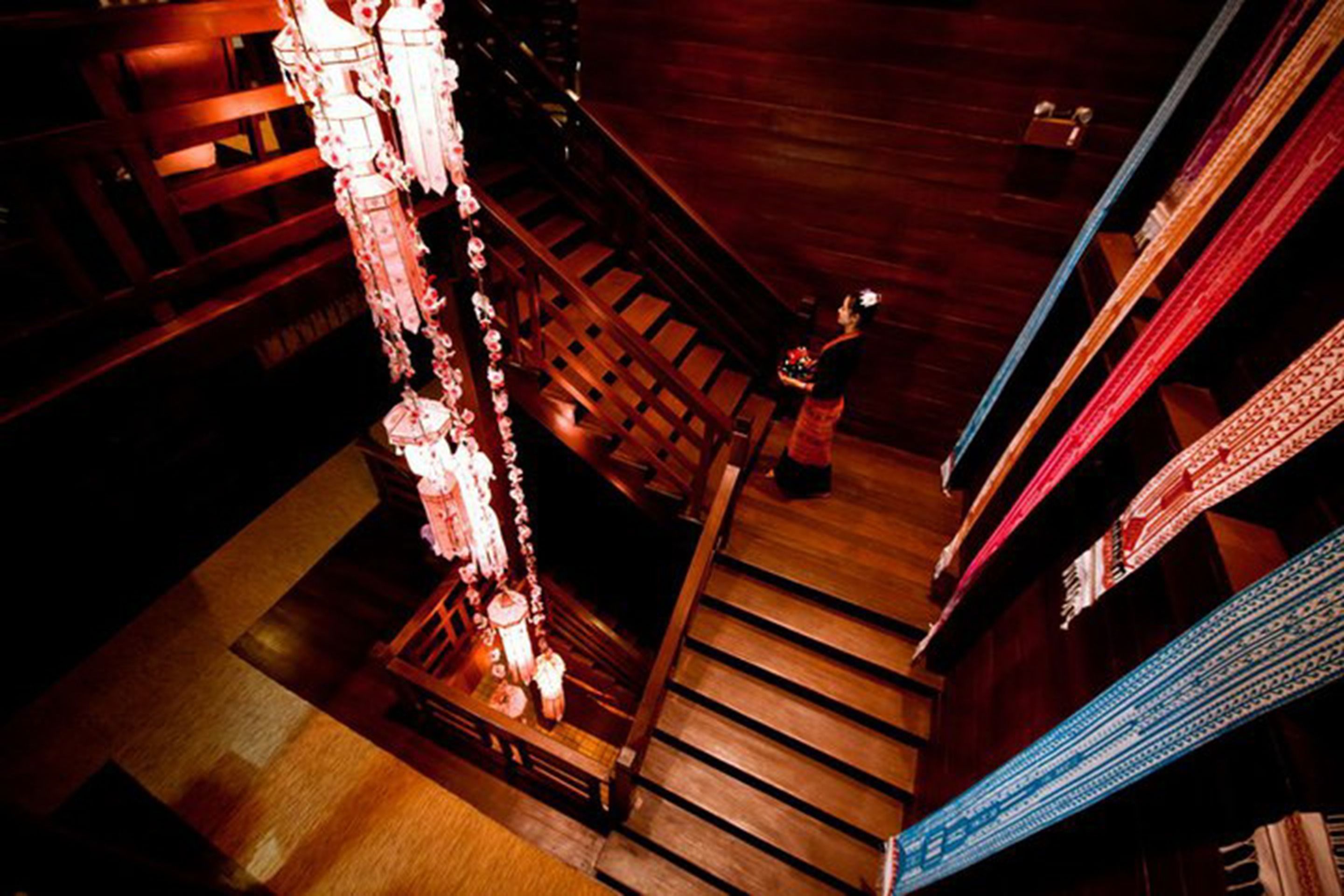 A wooden staircase with a decorative hanging ornament.