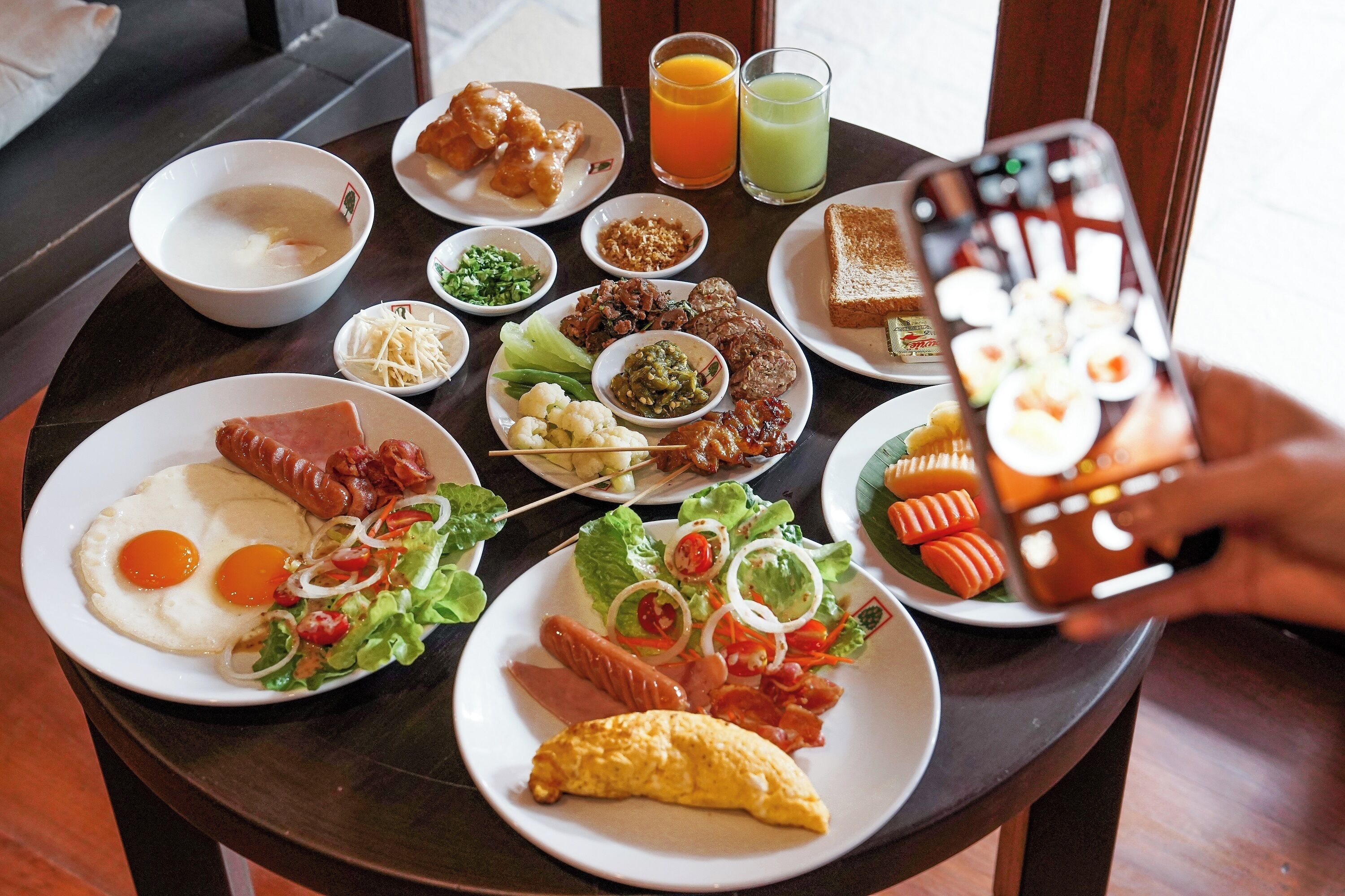 A breakfast table with various dishes including eggs, bacon, and toast.