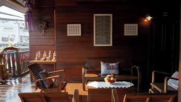 A wooden interior with a bench, chairs, and a table.
