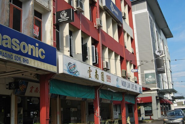 A building with multiple commercial establishments, including a trading company and a cafe.