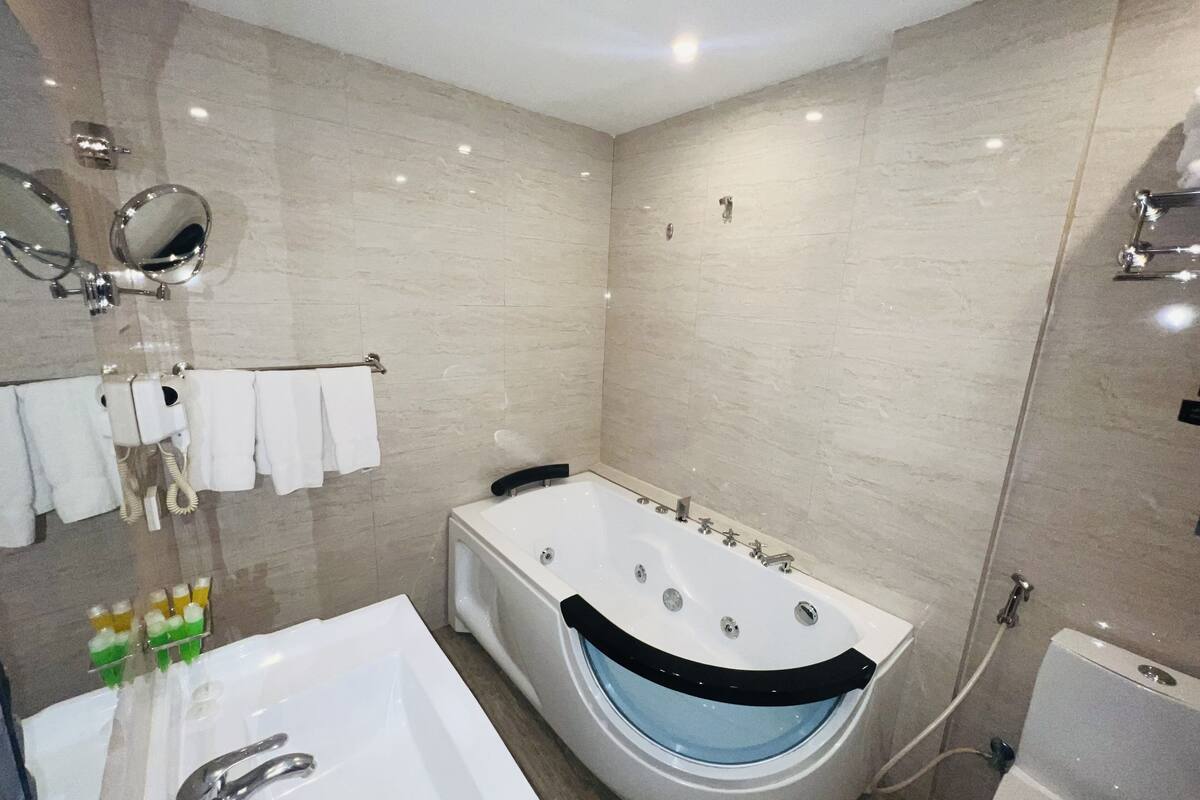 deluxe suite with spa bath | bathroom | free toiletries, hair dryer, bathrobes, slippers