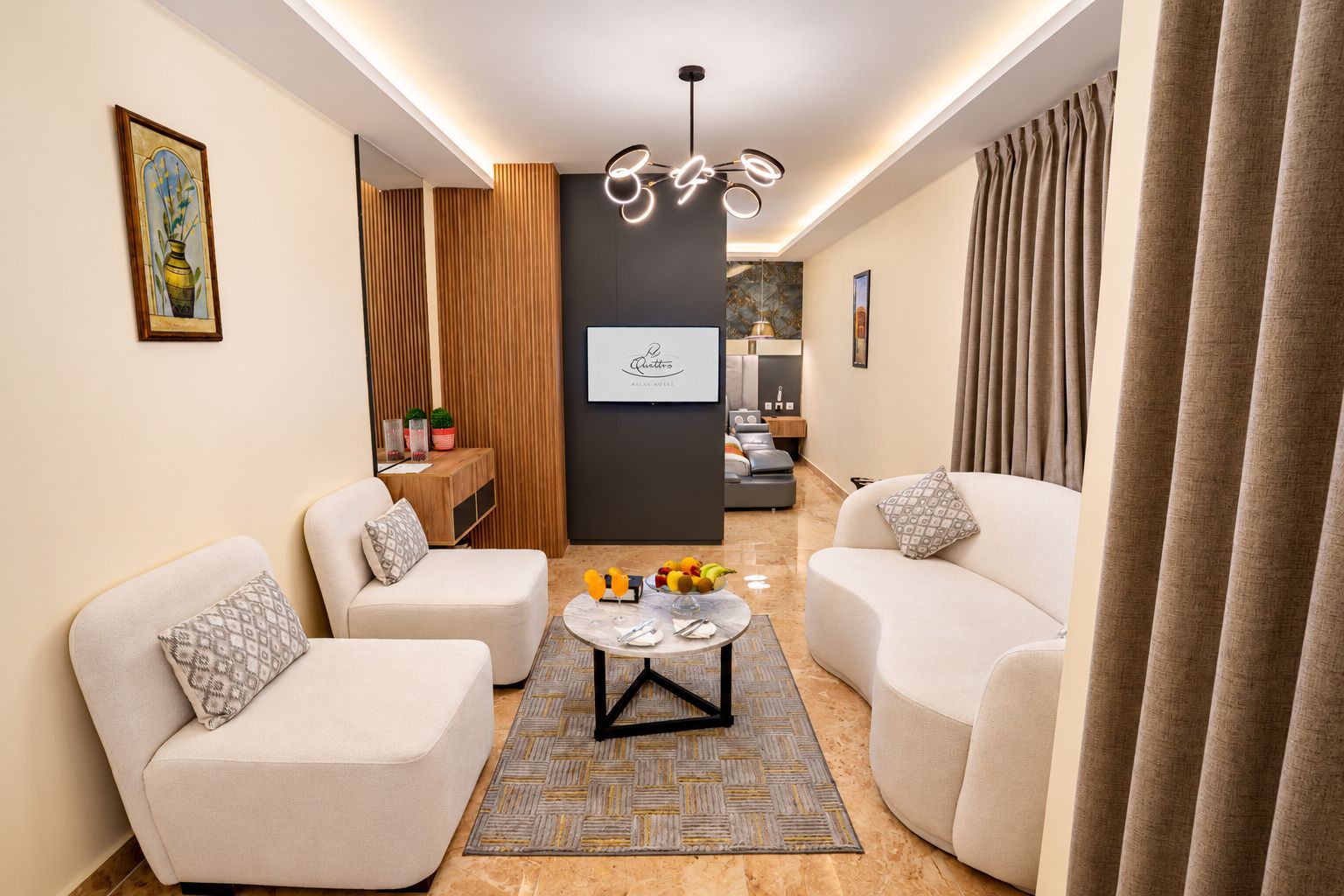 Una sala de estar moderna con dos sofás, una mesa de centro y un comedor con una cocina al fondo.