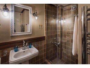 Designer toiletries, hair dryer, slippers, towels