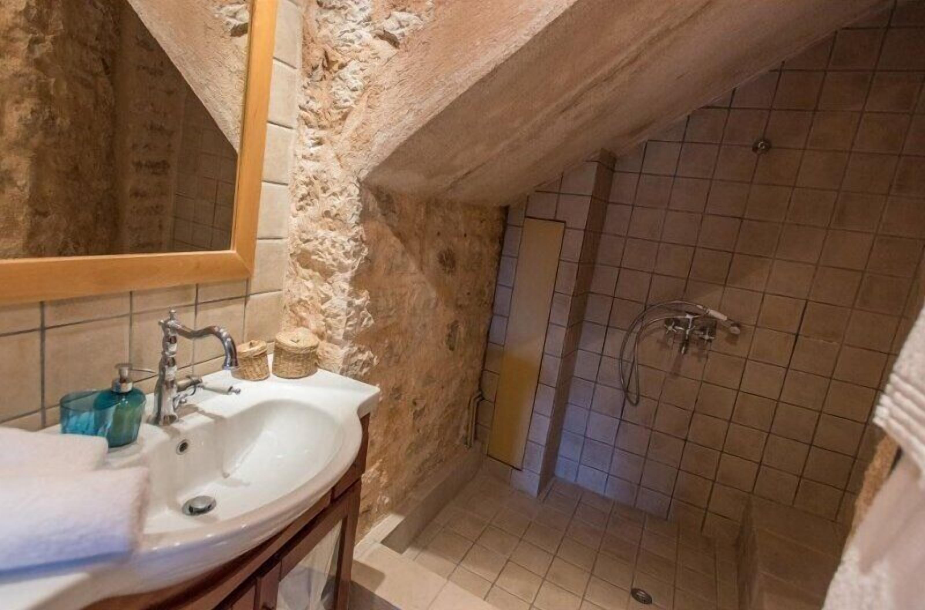 Designer toiletries, hair dryer, slippers, towels