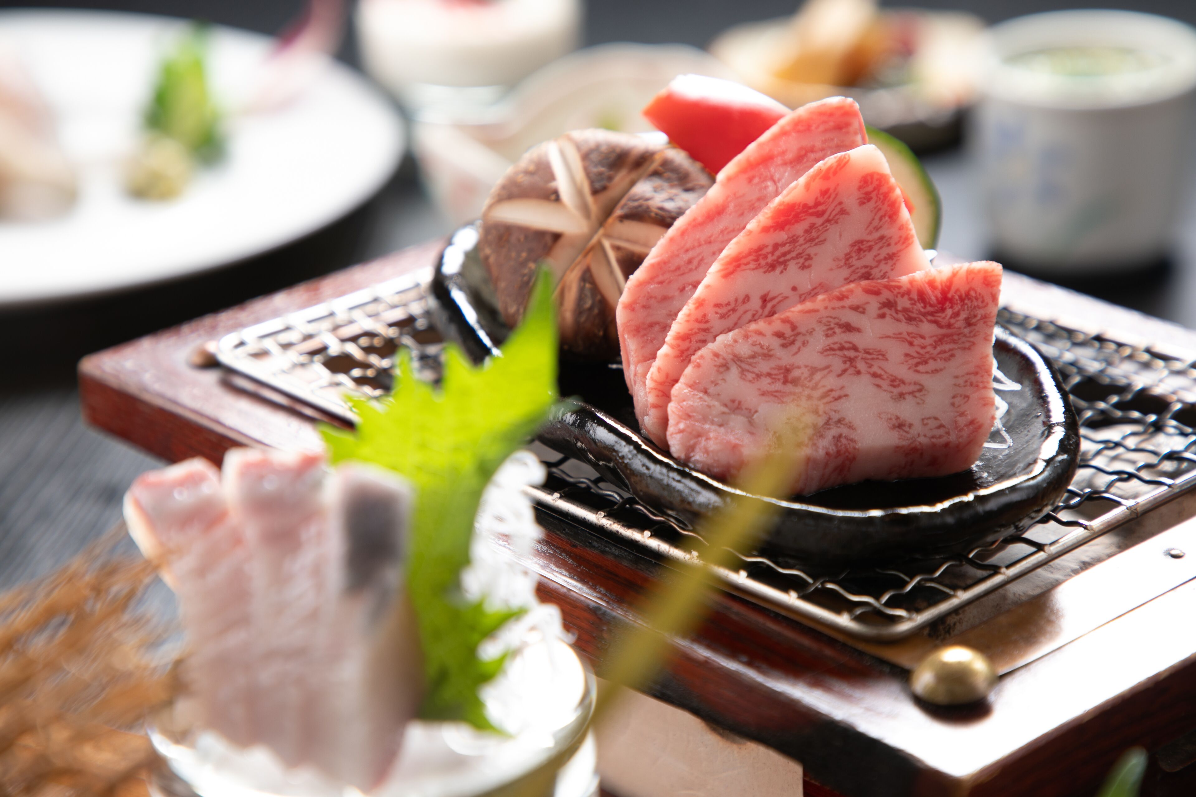 A sushi platter with various types of sushi on a wooden tray.