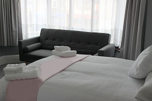 Senior Quadruple Room, 1 Bedroom, Shared Bathroom | Living area | Flat-screen TV