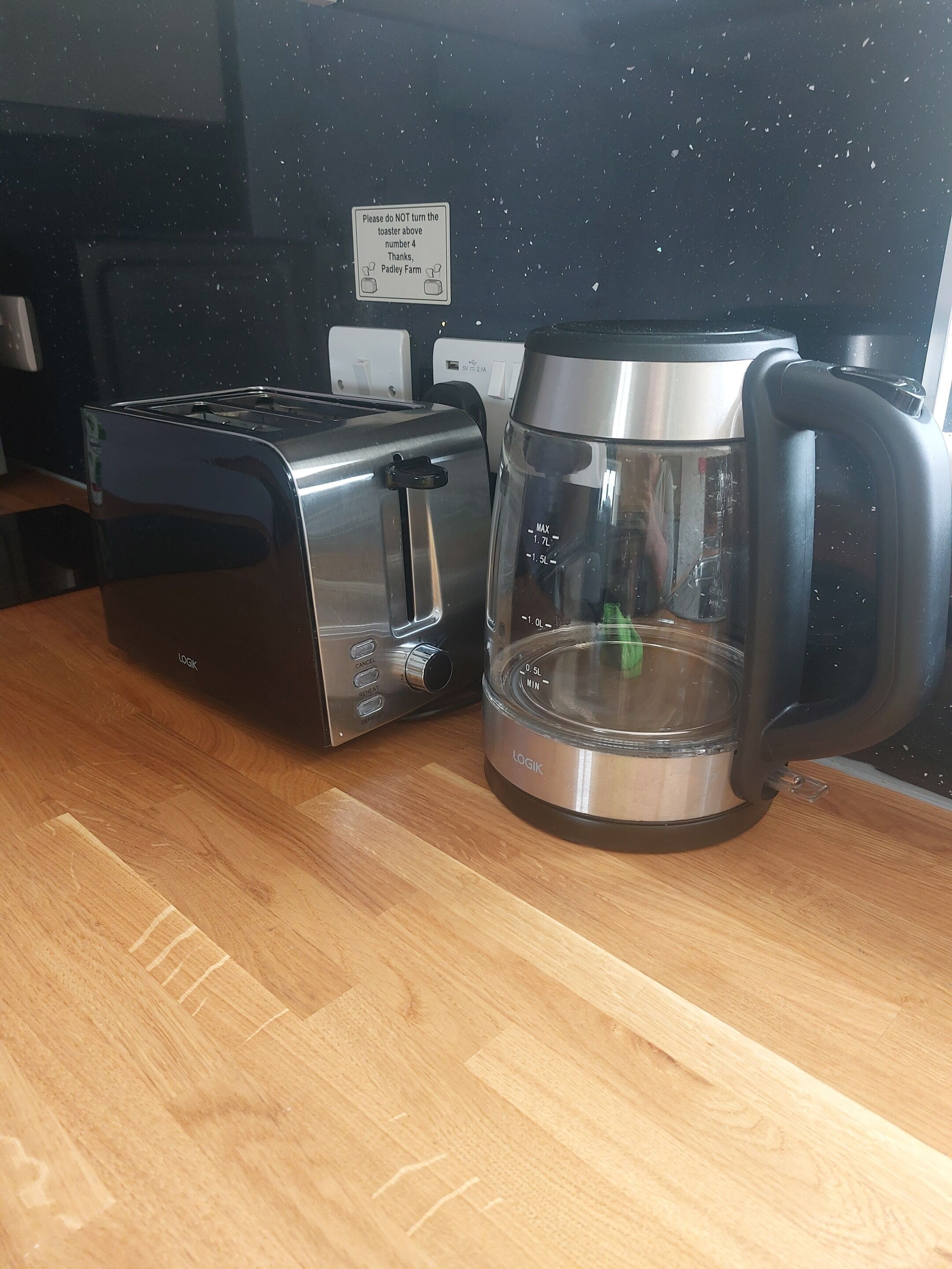 A toaster and a coffee maker on a wooden countertop.