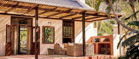 A house with a covered patio, a brick fireplace, and a satellite dish.