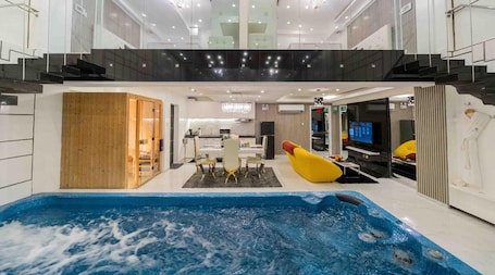 Deluxe Suite, 2 Bedrooms, Private Pool | Living area | 49-inch LED TV with digital channels, TV, tablet