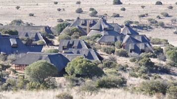 A cluster of thatched-roof houses in a rural setting.
